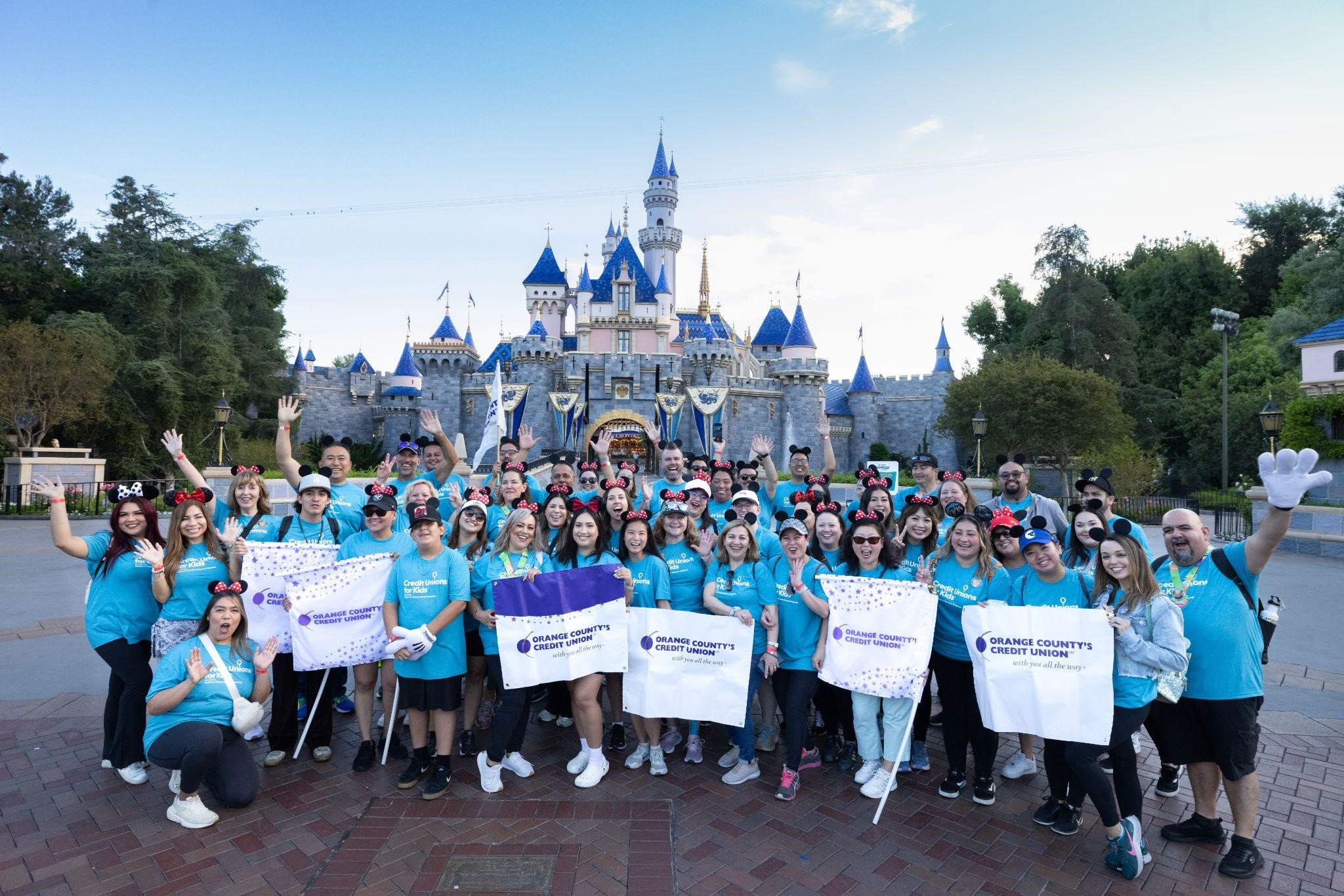 Orange County’s Credit Union CHOC Walk team celebrates outside of the Magic Castle at Disneyland.