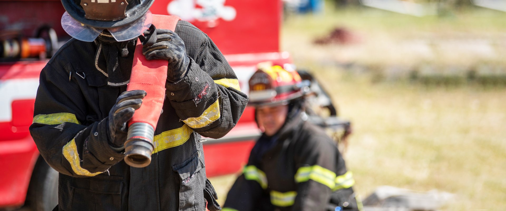 Firemen working to help put out a local fire in desktop view