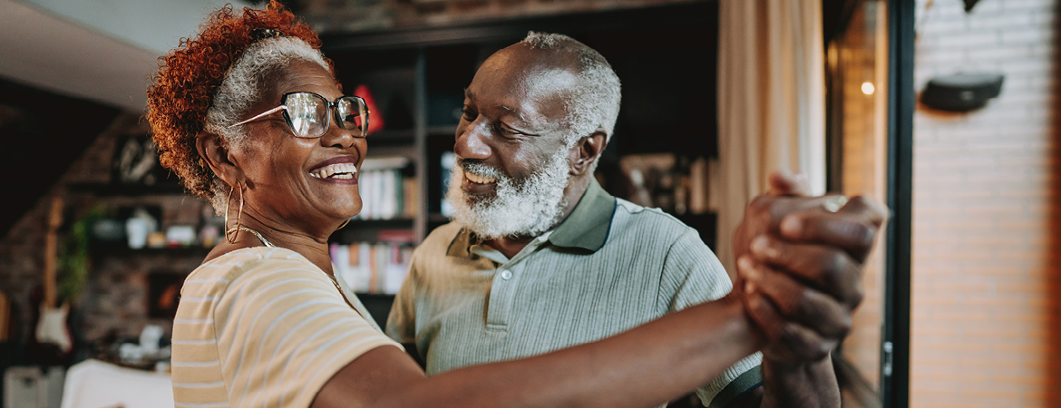 Senior couple dancing in living room of their manufactured home